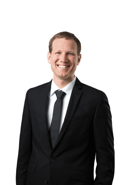 Luke Schlangen in a Black Suit with a Black Background